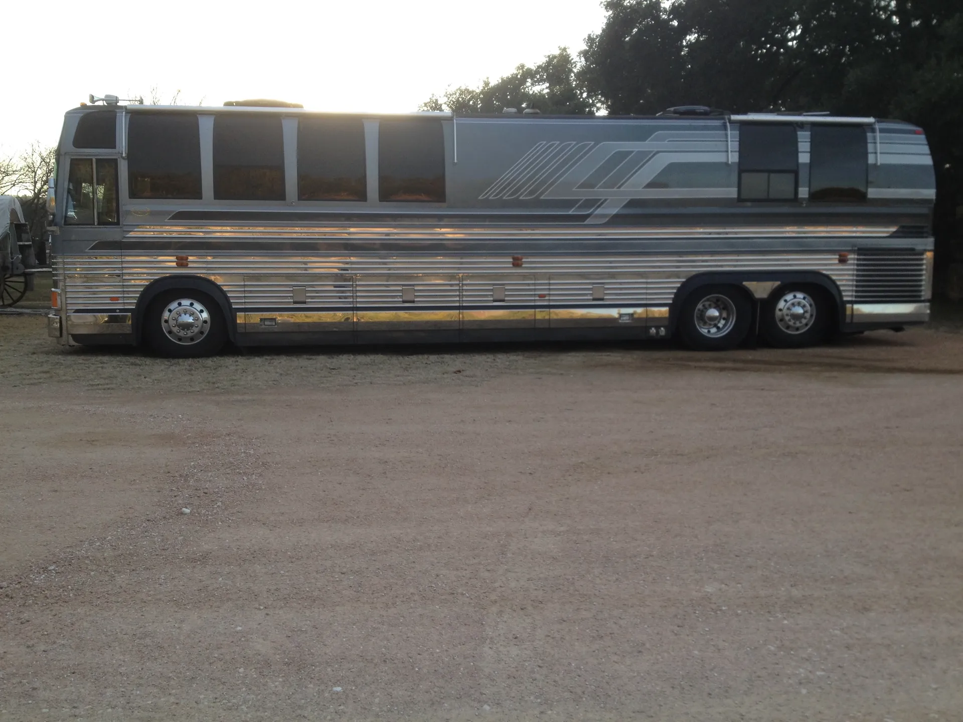 Driver side profile at dusk highlighting chrome storage bays