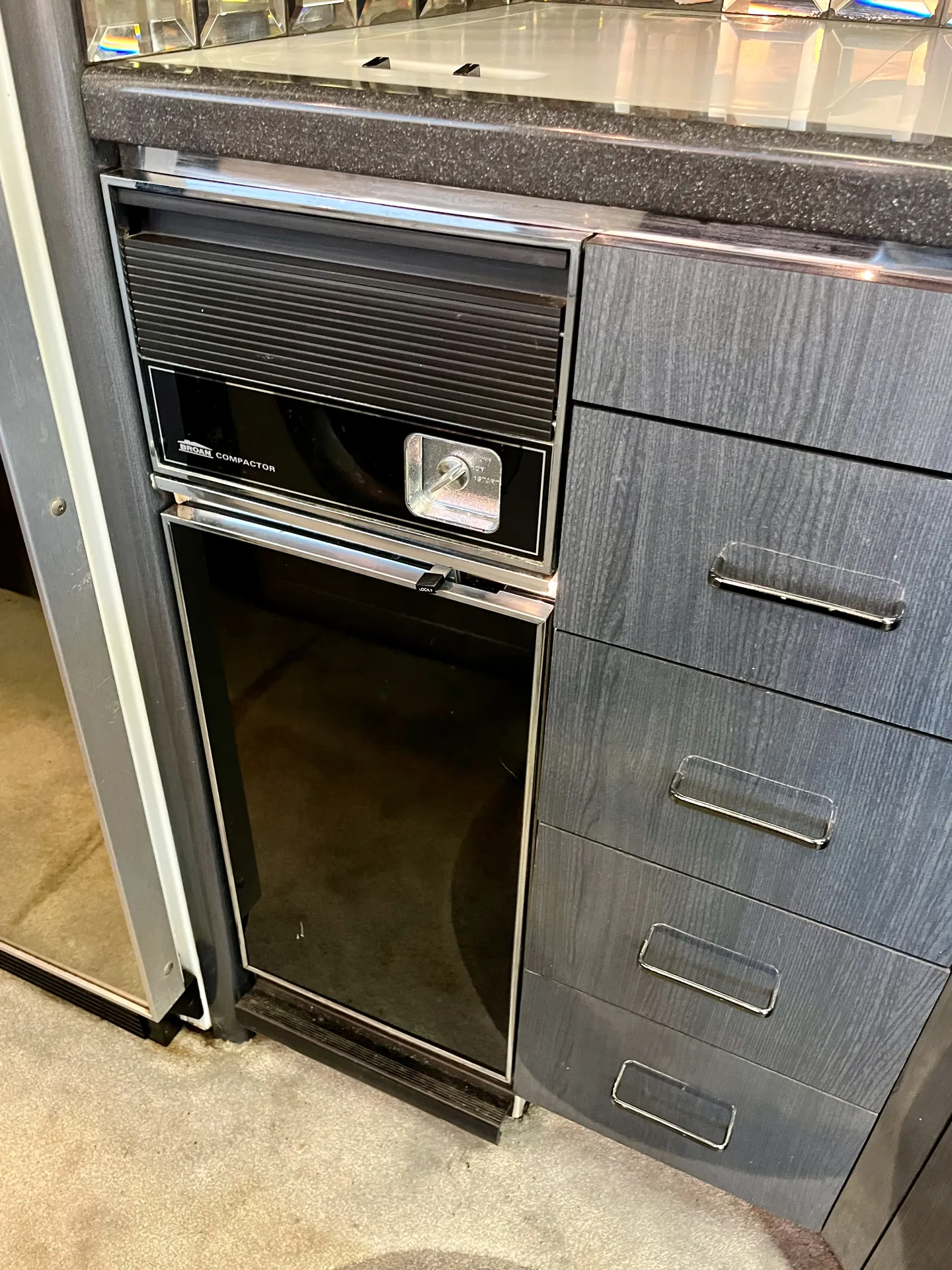 Built-in trash compactor and storage drawers